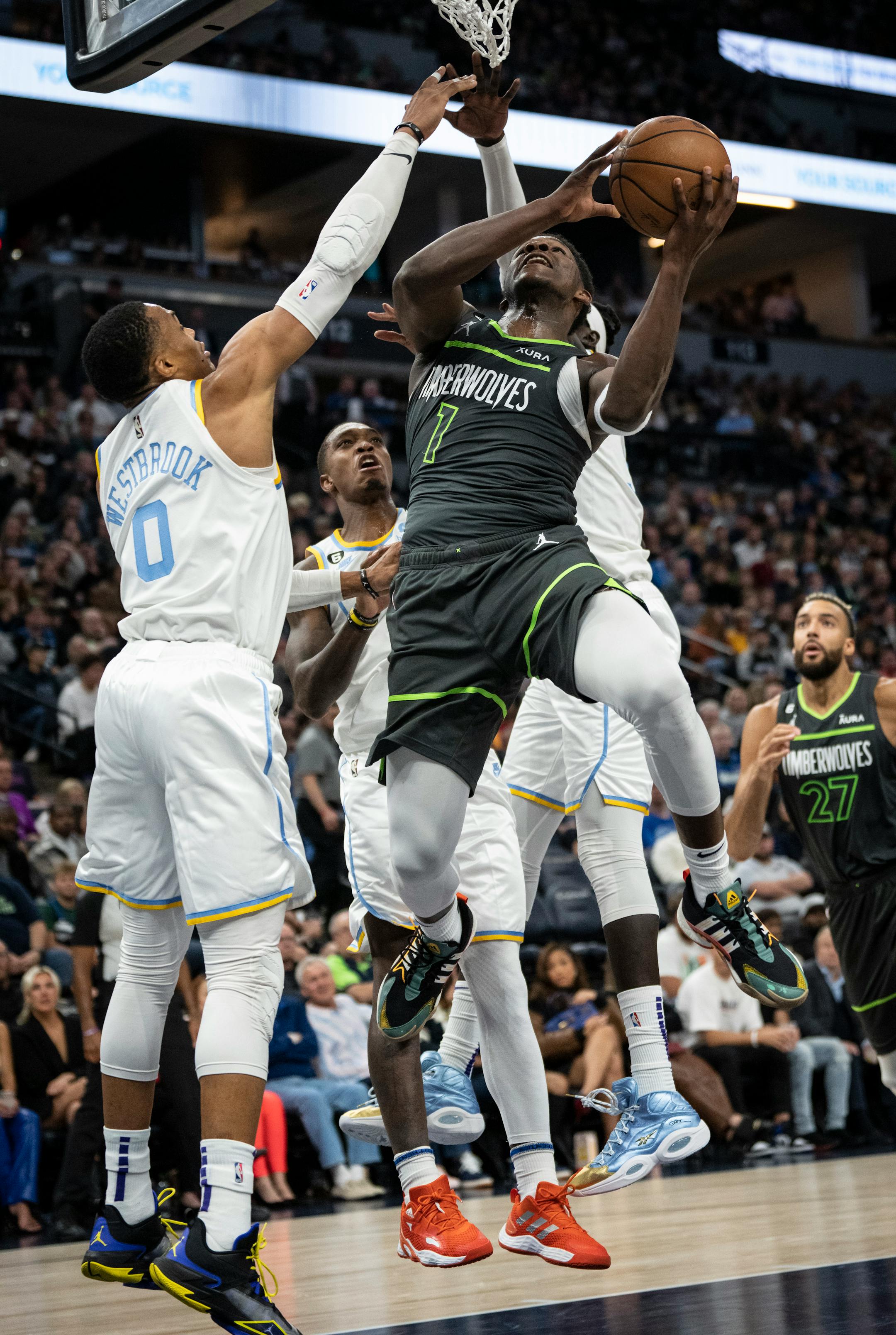 Minnesota Timberwolves forward Anthony Edwards (1) jumps for a shot against Los Angeles Lakers guard Russell Westbrook (0), Los Angeles Lakers guard Lonnie Walker IV (4) and Los Angeles Lakers forward Wenyen Gabriel (35) in the third quarter. A foul was called on the play.