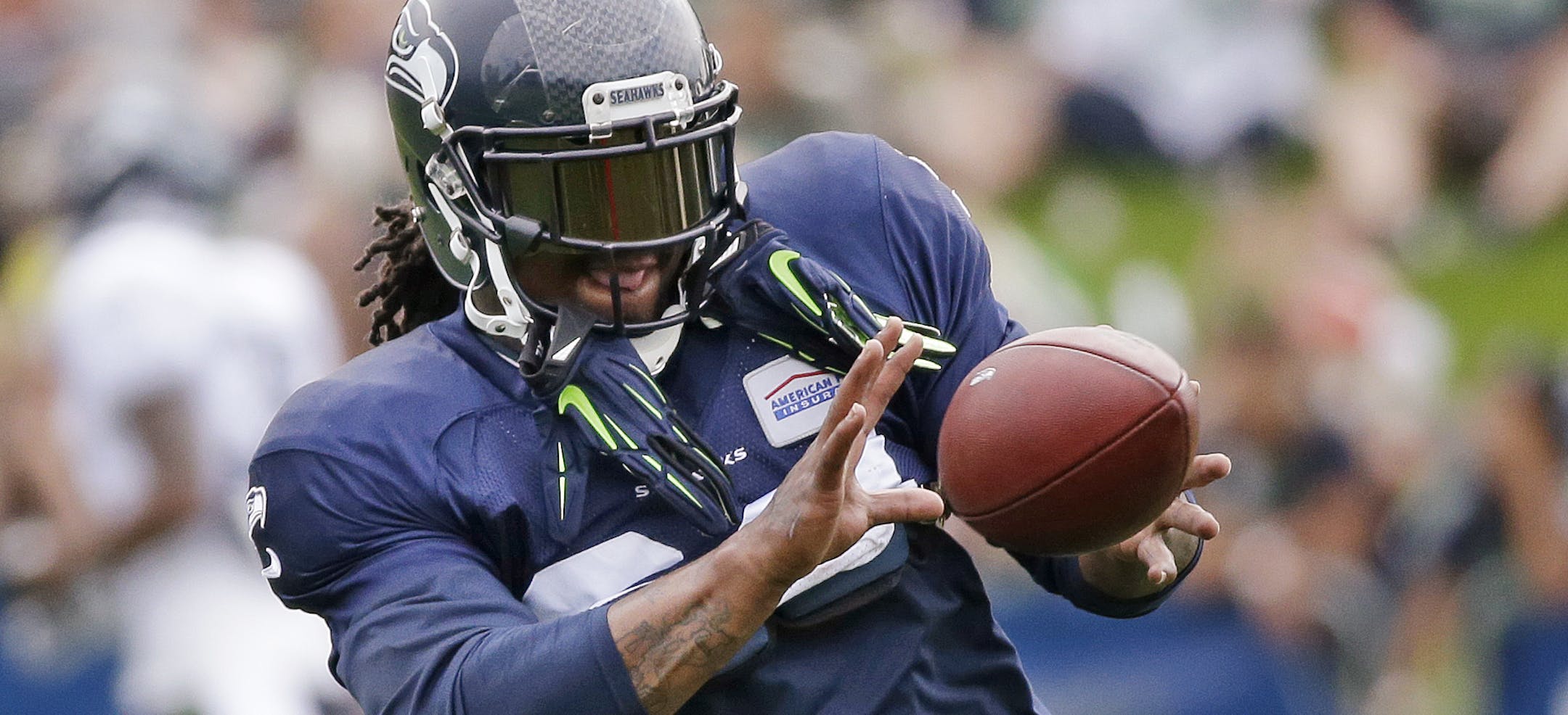 Seattle Seahawks' Marshawn Lynch catches a ball at an NFL football training camp Monday, Aug. 3, 2015, in Renton, Wash. (AP Photo/Elaine Thompson)