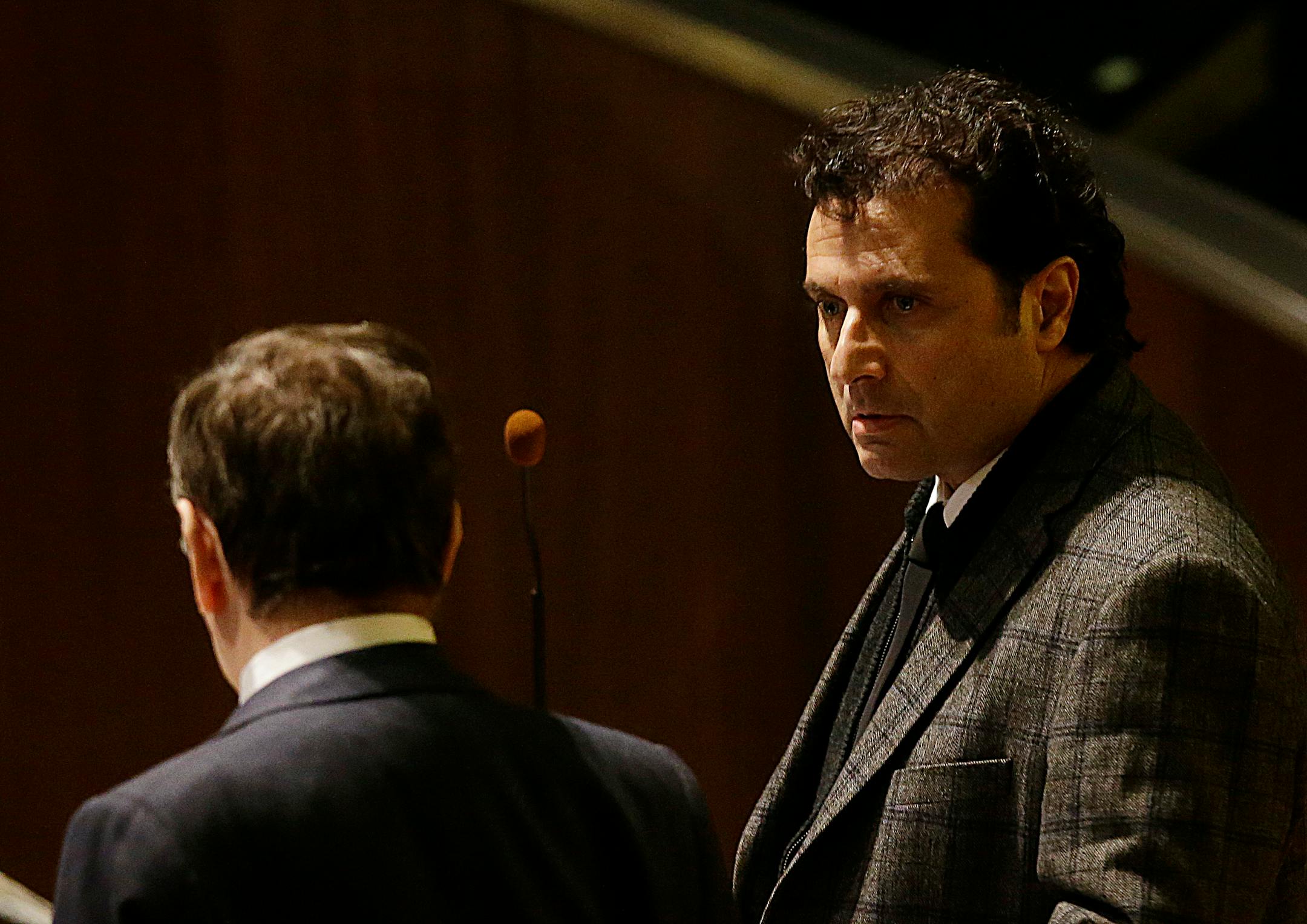 Francesco Schettino, right, attends his trial in Grosseto, Italy, Wednesday, Feb. 11, 2015. The captain of the capsized Costa Concordia luxury liner has been convicted of multiple charges of manslaughter and sentenced to 16 years in jail. Francesco Schettino wasn't present when Judge Giovanni Puliatti read out the verdict Wednesday night in a Grosseto theater. The verdict and sentencing brought a close to a trial that has been running since July 2013. (AP Photo/Gregorio Borgia)