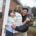 Bob Hudgins, right, a Ferguson City Council candidate for the 2nd ward, receives a hug from resident Sharon Smith as he canvasses a neighborhood in Fe