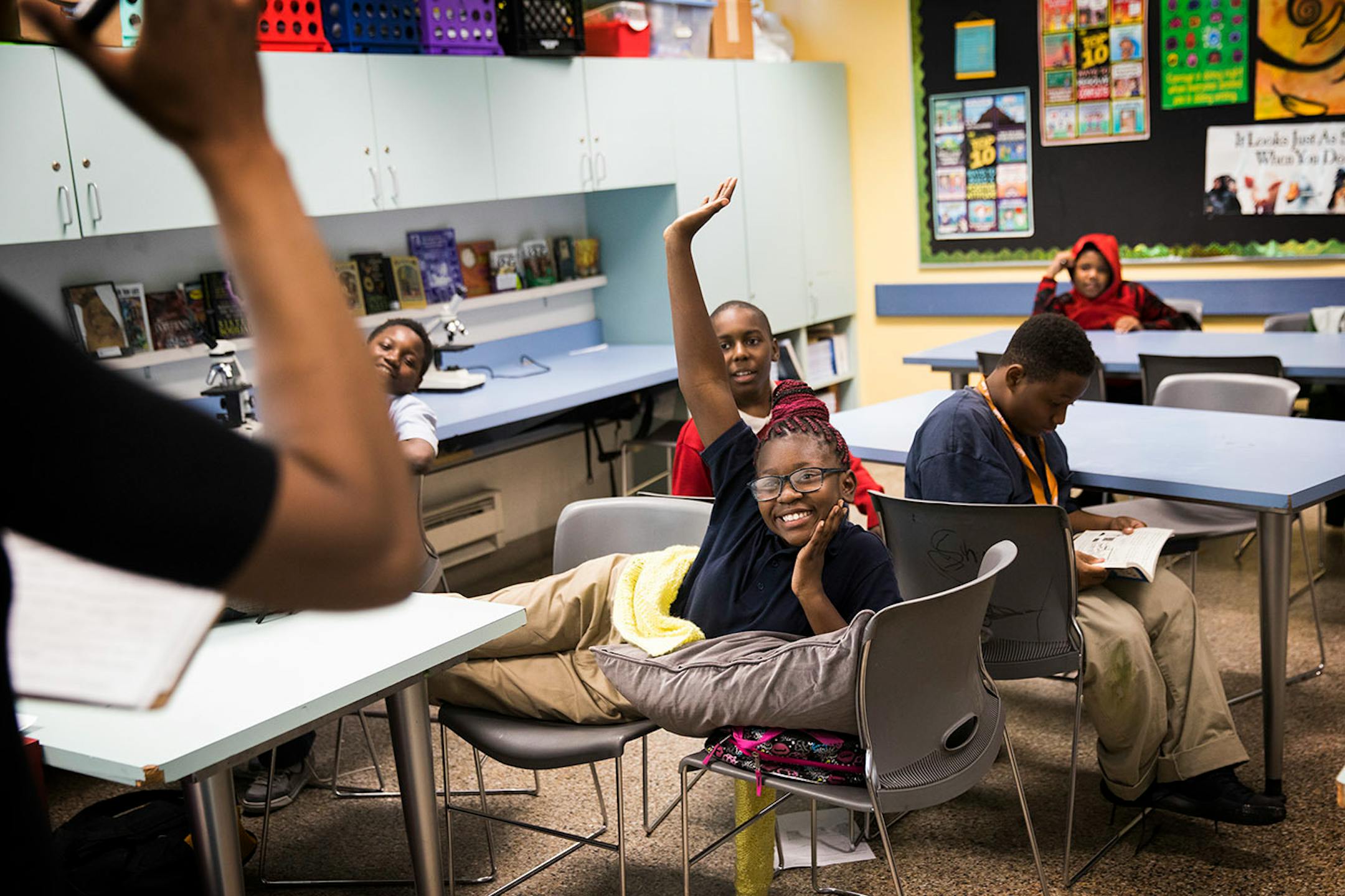 Ebonie Kennedy, 10, raises her hand during a game of MadLibs.