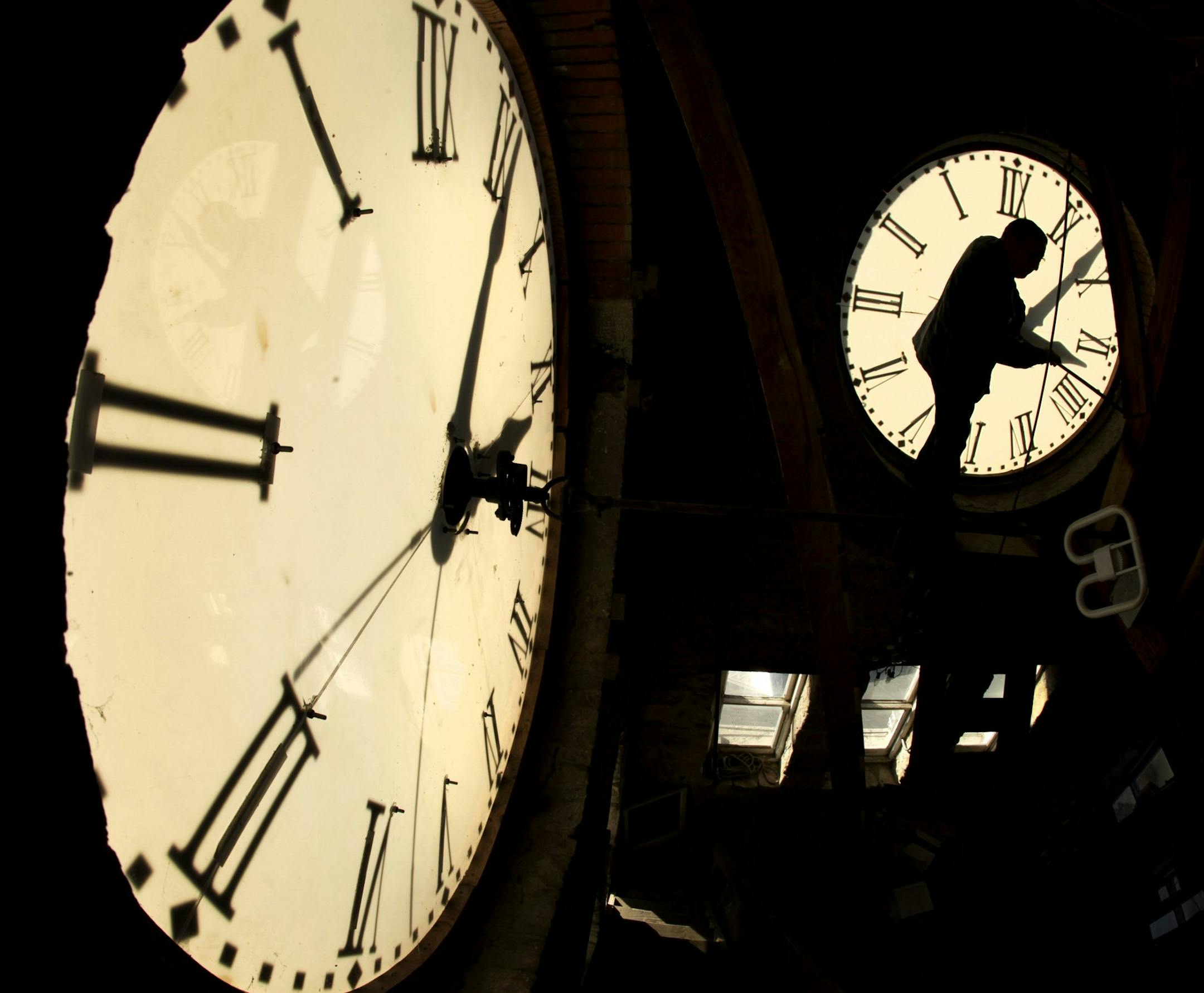 Custodian Ray Keen checks the time on a clock face after changing the time on the 97-year-old clock atop the Clay County Courthouse, Saturday, Nov. 6, 2010, in Clay Center, Kan. Keen was setting time back an hour in advance of the end of daylight savings time which occurs at 2 a.m. on Sunday. (AP Photo/Charlie Riedel)