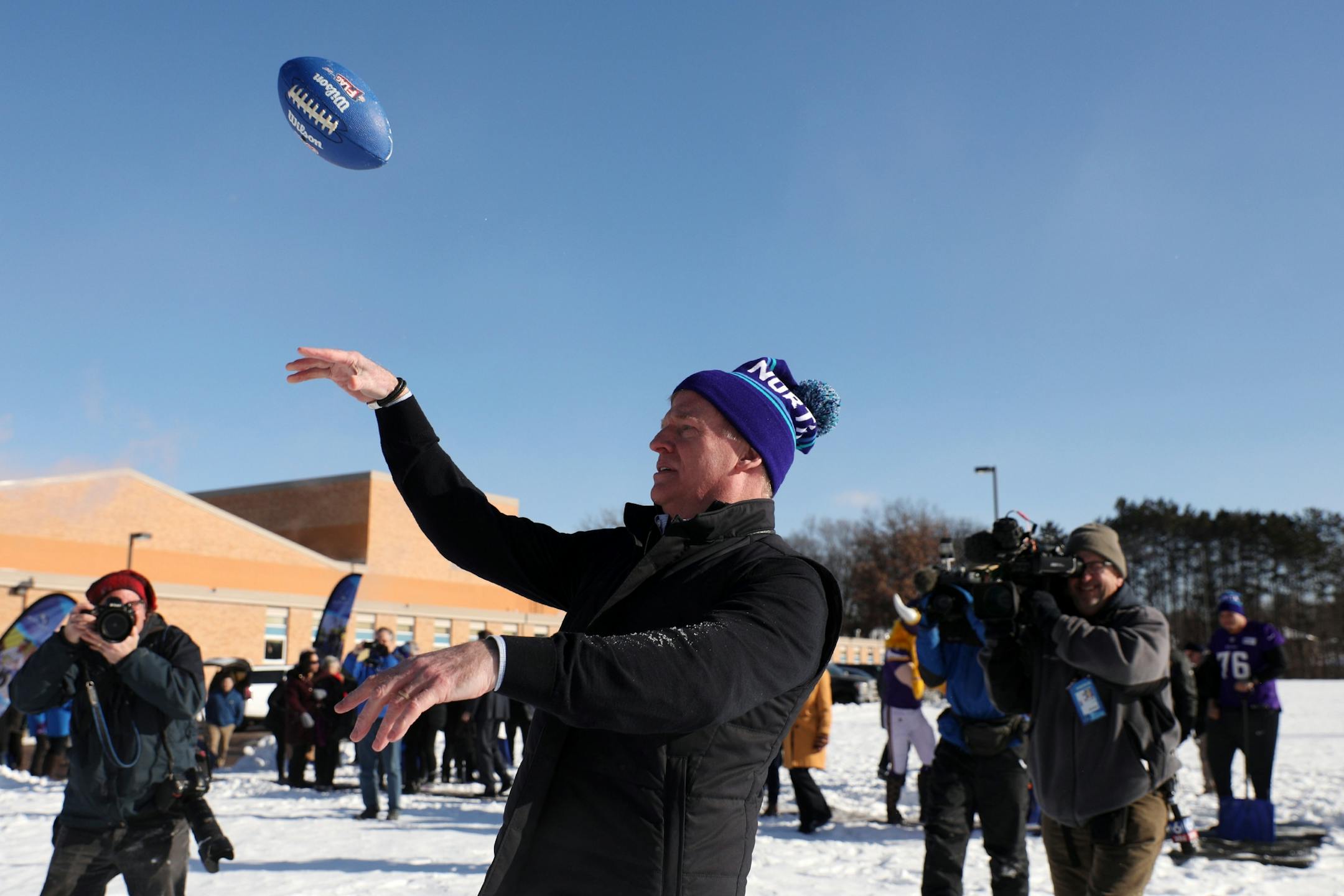 NFL Commissioner Roger Goodell thew a football with a group of students following a "snow shoveling ceremony" in place of ground breaking ceremony for the school's new athletic field.