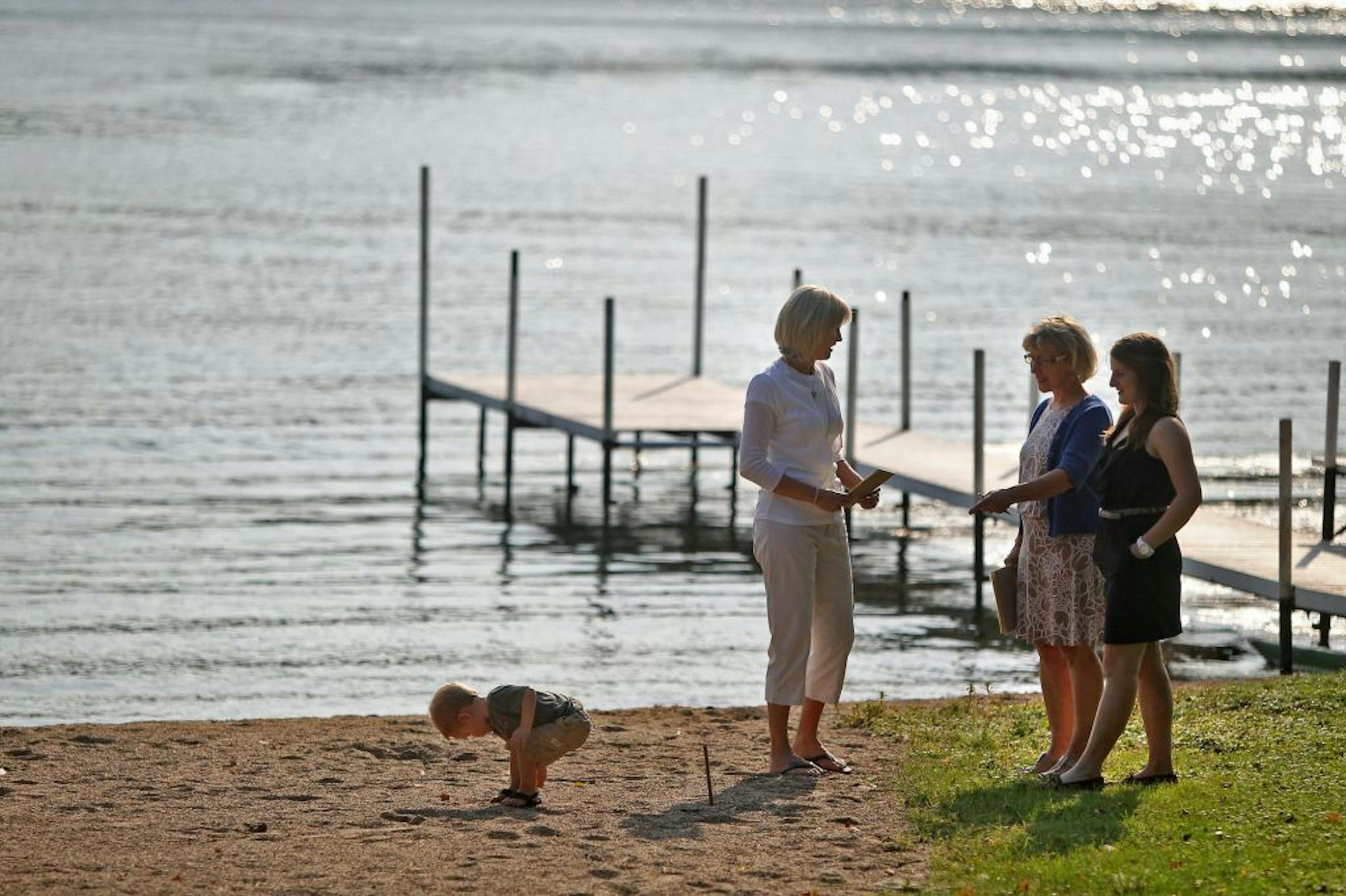 Realtor Virginia Lord, center, and assistant Jessica Pollock, right, gave a tour to Sandy Ryan, left, and her grandson Ryan Allman, of the home she just purchased on Christmas Lake in Chanhassen, MN, Thursday, August 20, 2012. There is a huge increase in the number of lakeshore home sales this year. (ELIZABETH FLORES/STAR TRIBUNE) ELIZABETH FLORES � eflores@startribune.com