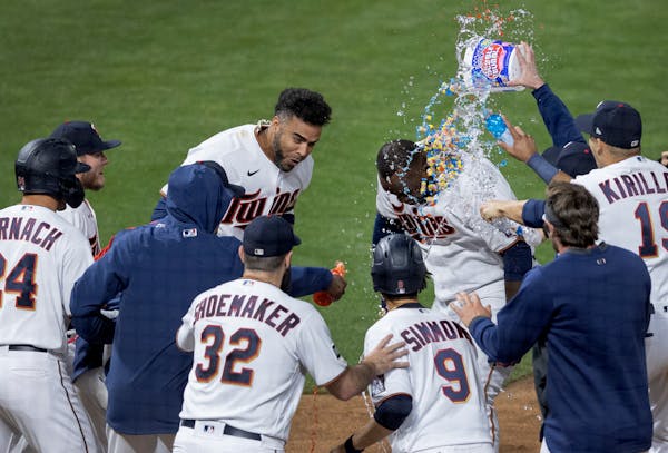 Minnesota Twins Miguel Sano was greeted by teammates after hitting a walk off home run in the twelfth inning.