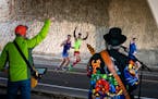 Runners cheered as the Burner Band/Cornhole Committee rocked "Sweet Home Alabama" and "Hey Joe" from under the Lake St Bridge along Mississippi River 