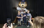 Twins' mascot T.C. poses for a photo with young fans, from left to right, Oliver Burkland, Winston Mielke, Wyatt Mielke and Charlie Burkland, at Twins