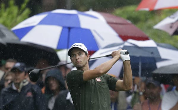 Adam Scott, of Australia, watches his tee shot on the 10th hole during the second round of the PGA Championship golf tournament at Oak Hill Country Cl