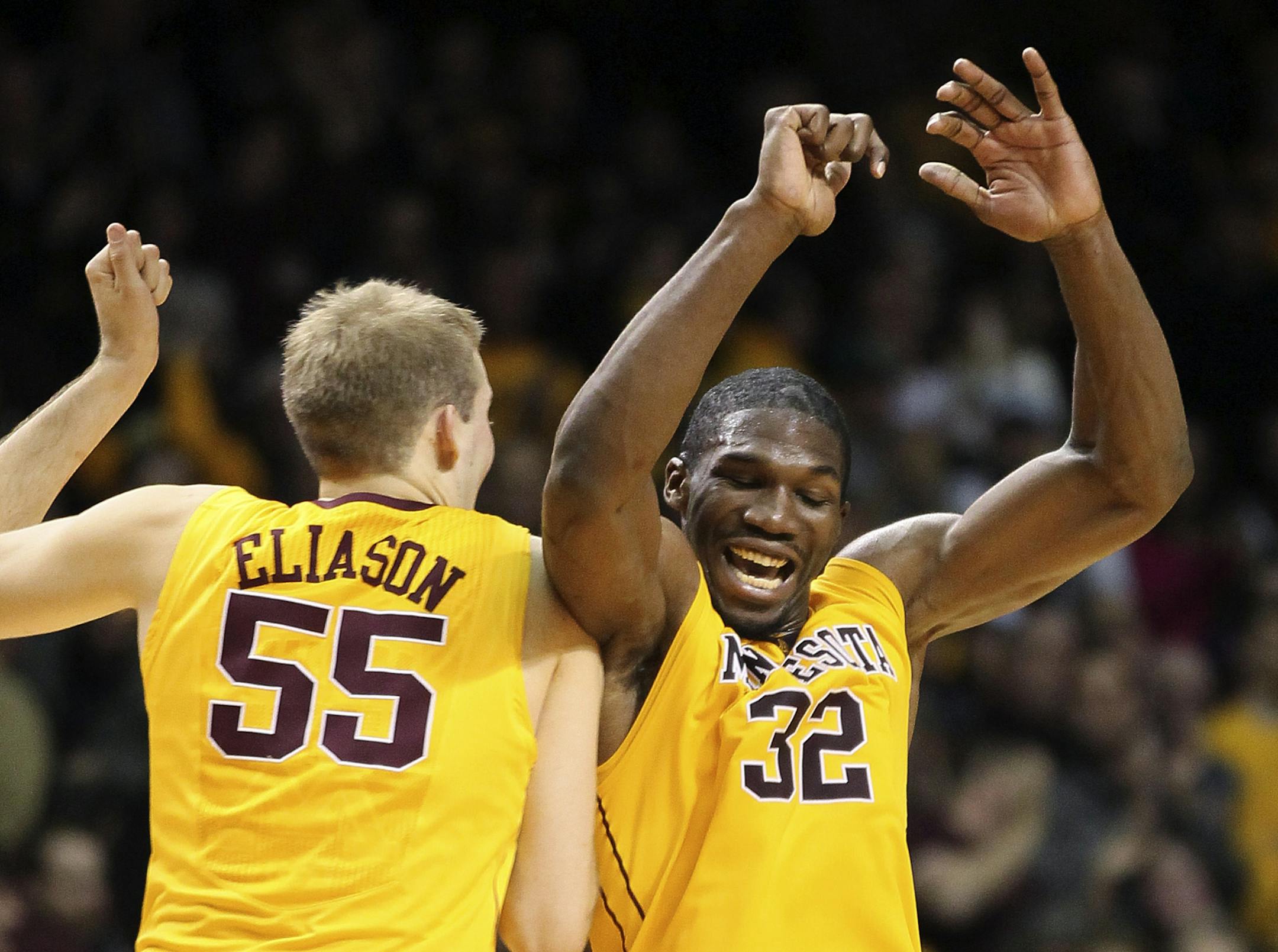 Minnesota forward Trevor Mbakwe celebrates with Elliott Eliason against Michigan State.
