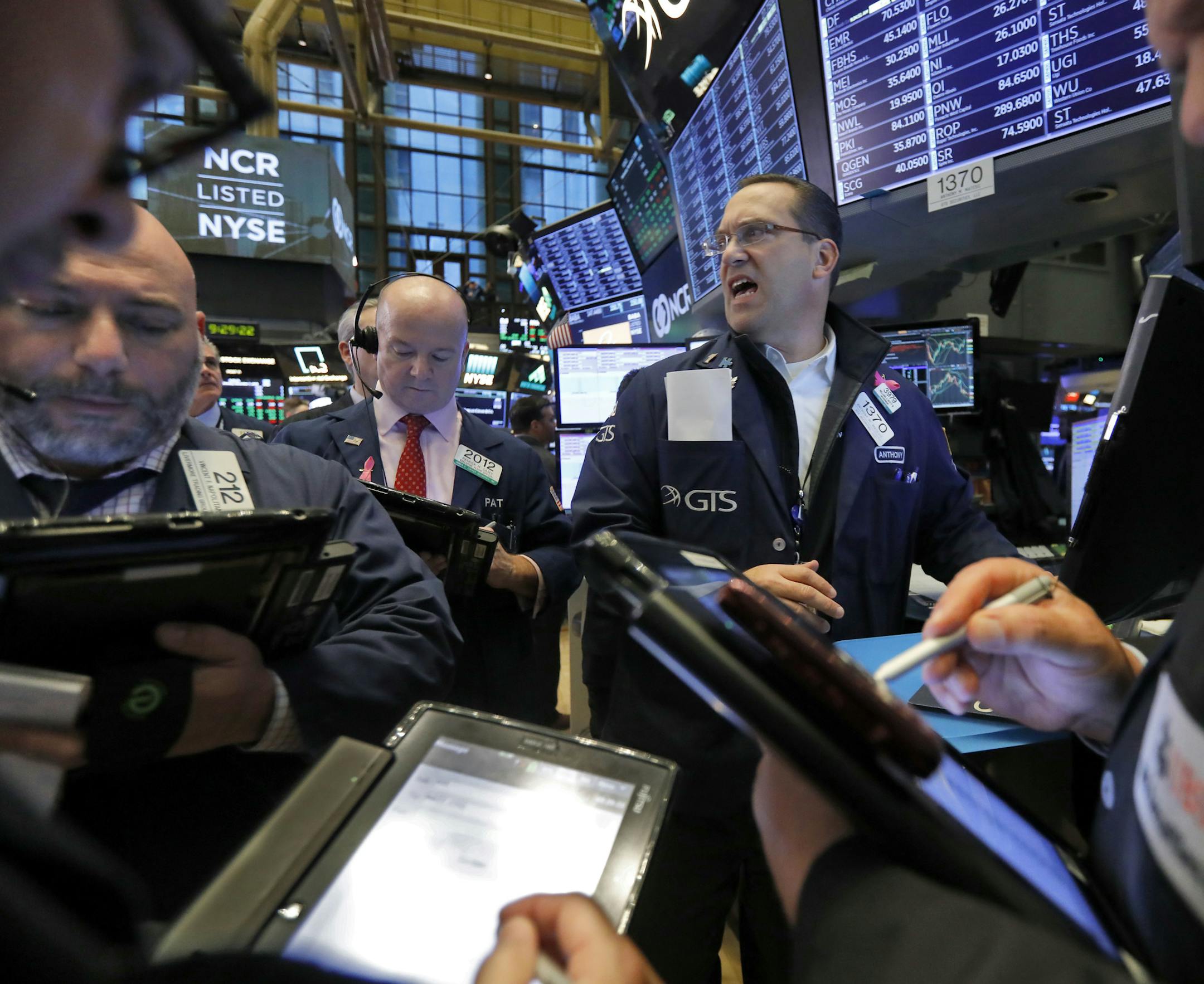 FILE- In this Wednesday, Nov. 7, 2018, file photo traders gather at the post of Anthony Matesic, center, on the floor of the New York Stock Exchange. The past decade has seen an explosion in new exchange-traded funds. Investors have flocked to ETFs because they trade like individual stocks, but offer the diversification benefits of mutual funds, all at a low cost. But not all funds attract investors, and ETFs are dying off at a near-record rate this year. (AP Photo/Richard Drew, File)