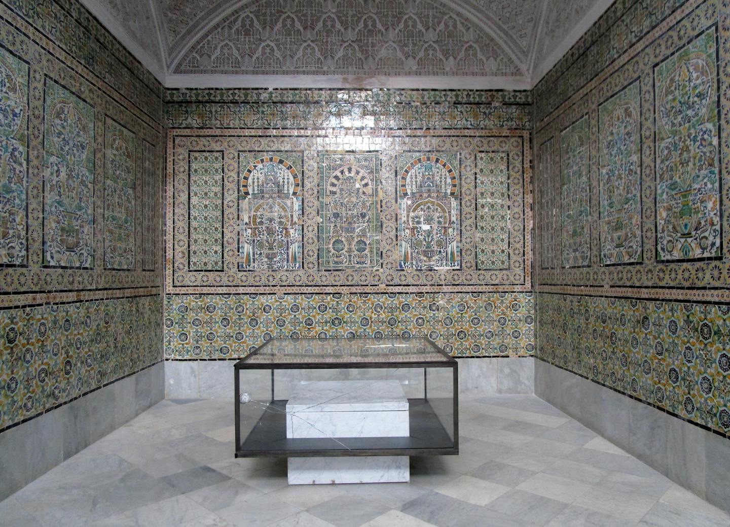 A display case pierced by a bullet in 2015, preserved in a tiled chamber of the old palace, is a reminder of the context in which the Bardo museum perseveres. (Gayla Marty)