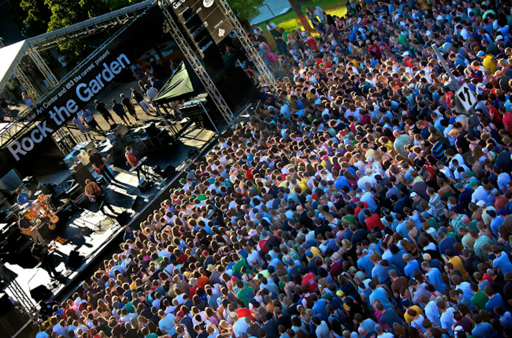 Fans enjoy the sun and the band the New Pornographers at the "Rock the Garden" concert.