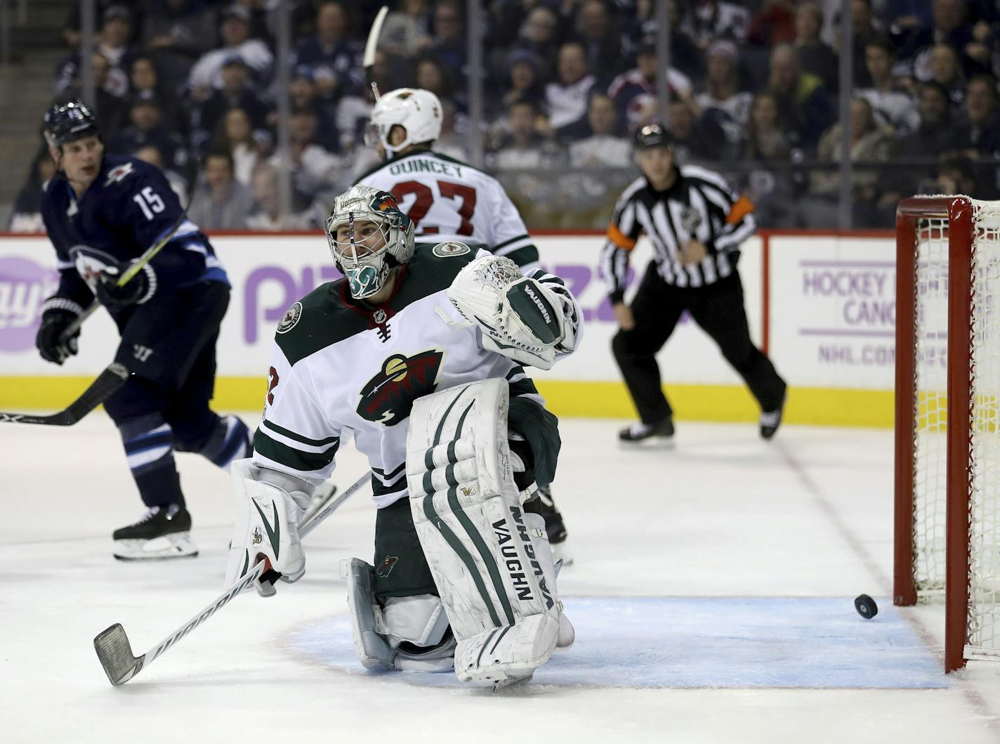 Minnesota Wild goalie Alex Stalock (32) looks on after Winnipeg Jets' Mathieu Perreault (85) scored during second period NHL hockey action in Winnipeg, Monday, Nov. 27, 2017. (Trevor Hagan/The Canadian Press via AP)