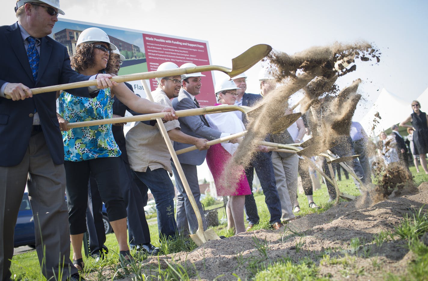 Officials including Sen. Bobby Joe Champion (not pictured or blocked), Congressman Keith Ellison (in tan shirt), Broadway Flats owner and developer Dean Rose, and city councilwomen Barbara Johnson, ceremoniously threw dirt with other project officials during a groundbreaking ceremony for Broadway Flats in Minneapolis, Minn. on Wednesday, May 27, 2015. Minneapolis Mayor Betsy Hodges spoke at the ceremony but left before the groundbreaking. ] RENEE JONES SCHNEIDER &#x2022; reneejones@startribune.c