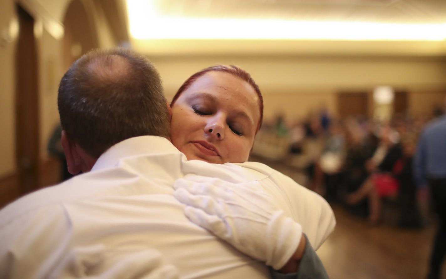 Meghan Smelter hugged her father, retried Minneapolis Police Officer Greg Smelter, after he pinned her police badge on her uniform just before she took the oath of office with the other recruits in her class Wednesday evening. Greg Smelter served in the MPD 25 years before retiring. ] JEFF WHEELER &#xef; jeff.wheeler@startribune.com Eight new members of the Minneapolis Police Department were sworn in Wednesday evening, June 1, 2016 in a ceremony at St. Mary's Greek Orthodox Church. In addition,