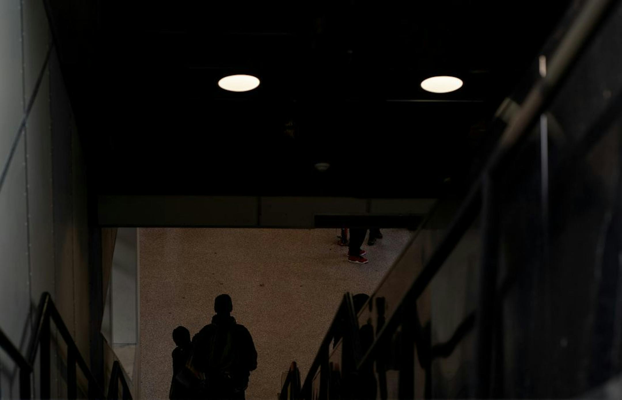 Two young men walked down the steps on the LRT Lake Street Station.