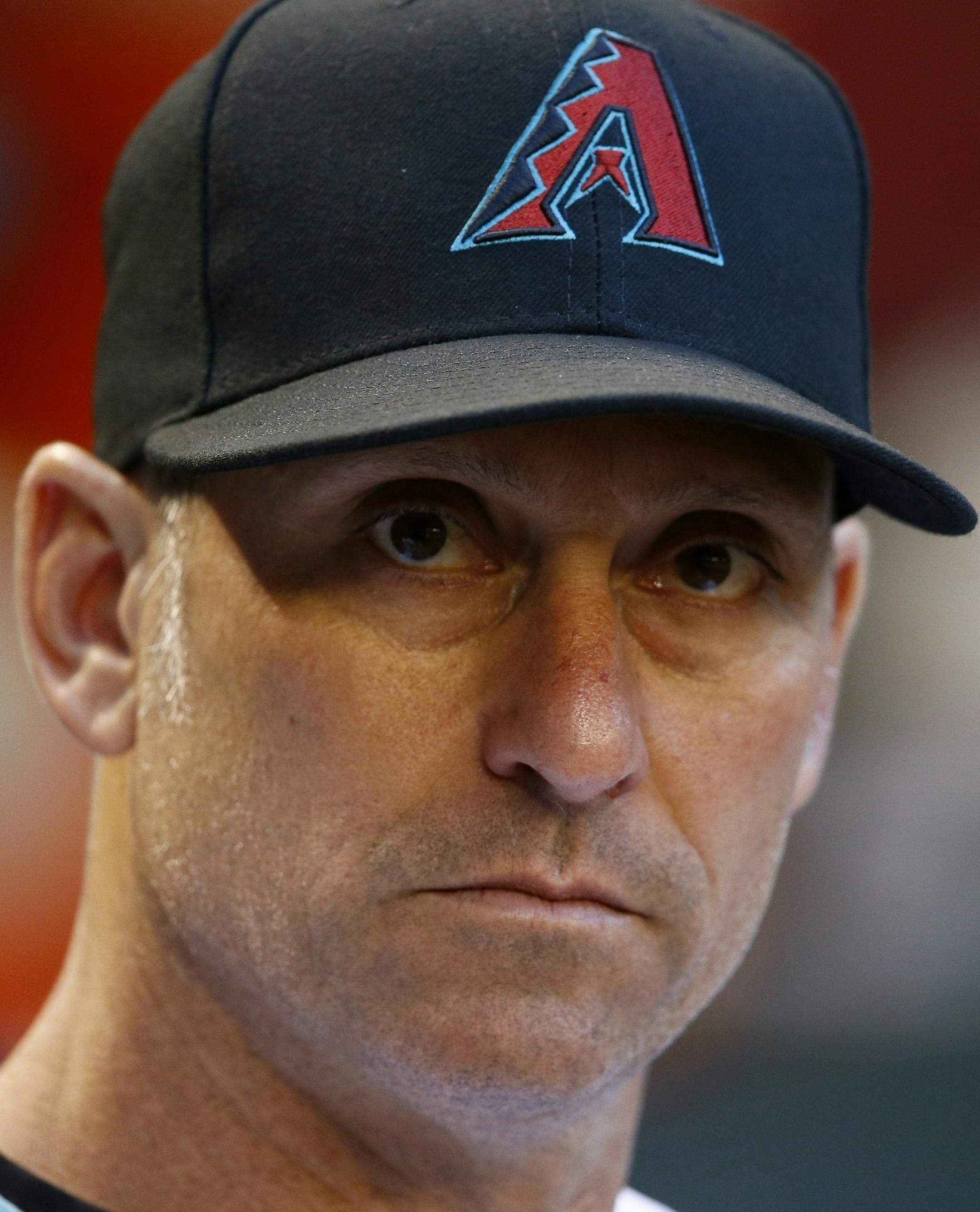 FILE - In this June 9, 2017, file photo, Arizona Diamondbacks' Torey Lovullo pauses in the dugout prior to a baseball game against the Milwaukee Brewers, in Phoenix. The Diamondbacks were one of baseballís big surprises a year ago. The surprise this year would be if they donít keep winning. ``Last year we kind of snuck up on people and had to earn their respect,íí said Lovullo, the National League manager of the year in his first season in the desert. (AP Photo/Ross D. Frankl