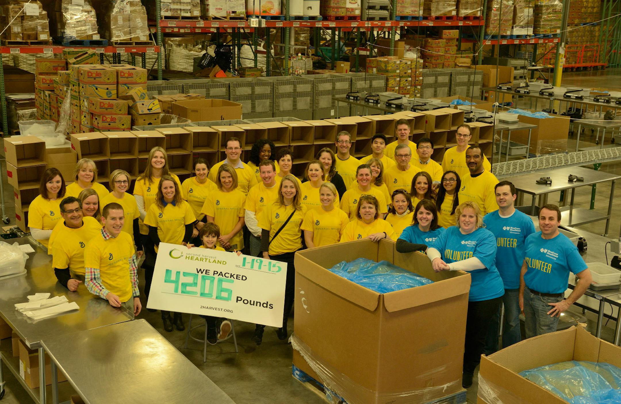 Volunteers from General Mills and Blue Cross at a Second Harvest event during an MLK Day effort in 2014.