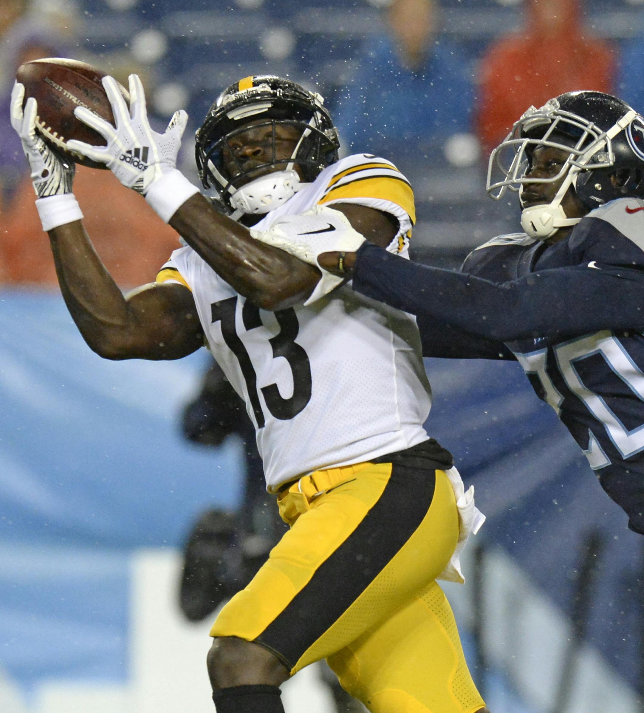 Pittsburgh Steelers wide receiver James Washington (13) catches a 41-yard touchdown as he is defended by Tennessee Titans defensive back Kenneth Durden (20) in the first half of a preseason NFL football game Sunday, Aug. 25, 2019, in Nashville, Tenn. (AP Photo/Mark Zaleski)