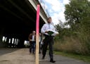 Southwest LRT officials toured the area where a 10-foot wall is proposed. Here, Brian Runzel, SWLRT Construction Director, walked under the I-394 Brid