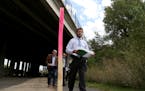 Southwest LRT officials toured the area where a 10-foot wall is proposed. Here, Brian Runzel, SWLRT Construction Director, walked under the I-394 Brid
