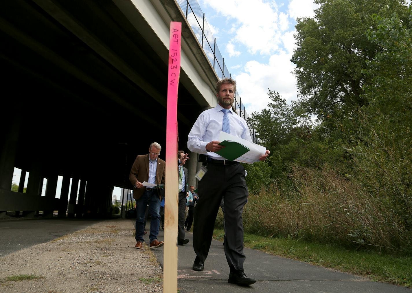 Southwest LRT officials toured the area where a 10-foot wall is proposed. Here, Brian Runzel, SWLRT Construction Director, walked under the I-394 Bridge near the Bryn Mawr Station Area during a tour in September.