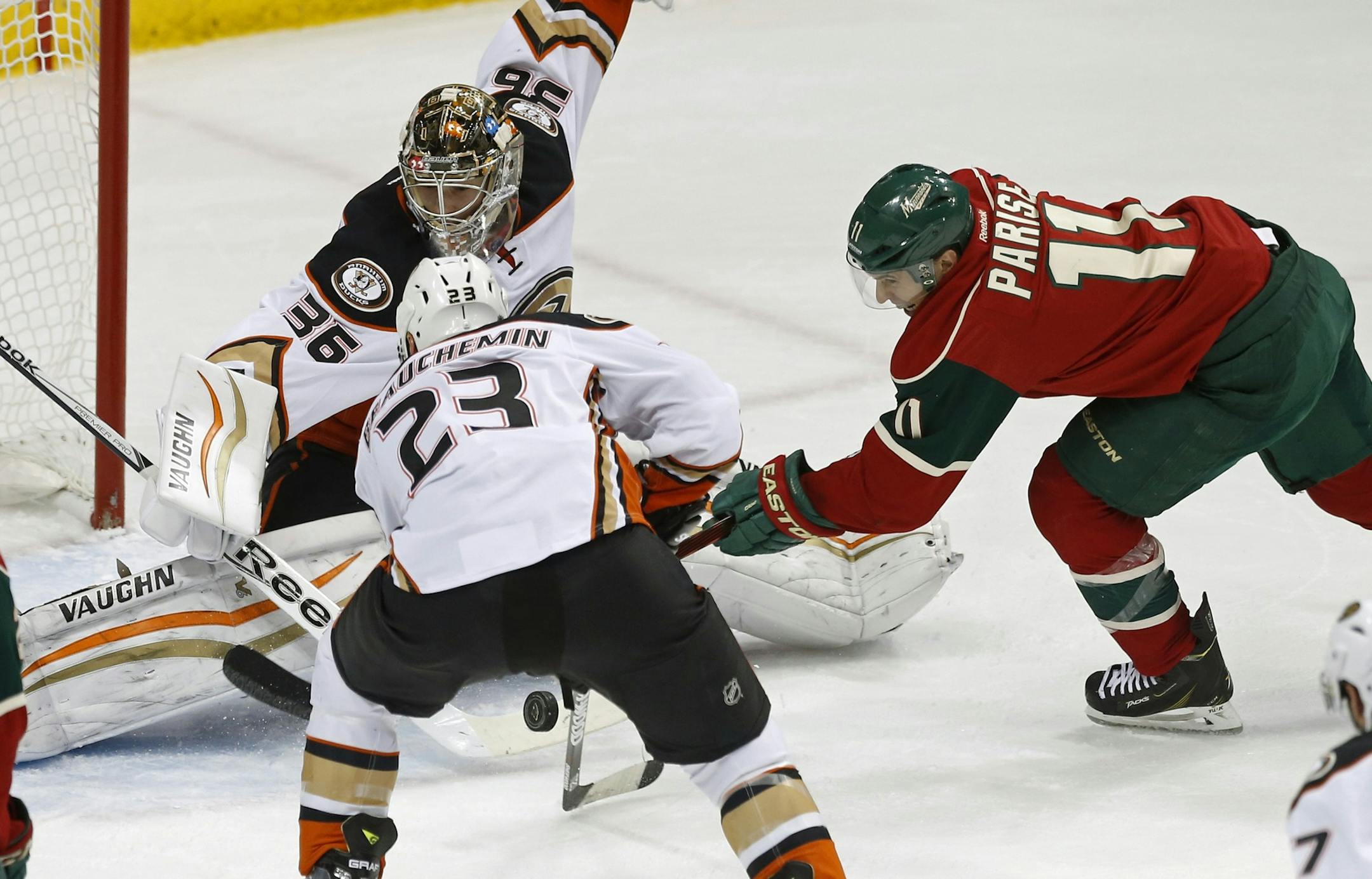 Anaheim Ducks’ Francois Beauchemin, left, helps goalie John Gibson defend the net as Minnesota Wild’s Zach Parise, right, attempts a shot in the first period of an NHL hockey game, Friday, March 13, 2015, in St. Paul, Minn. (AP Photo/Jim Mone)