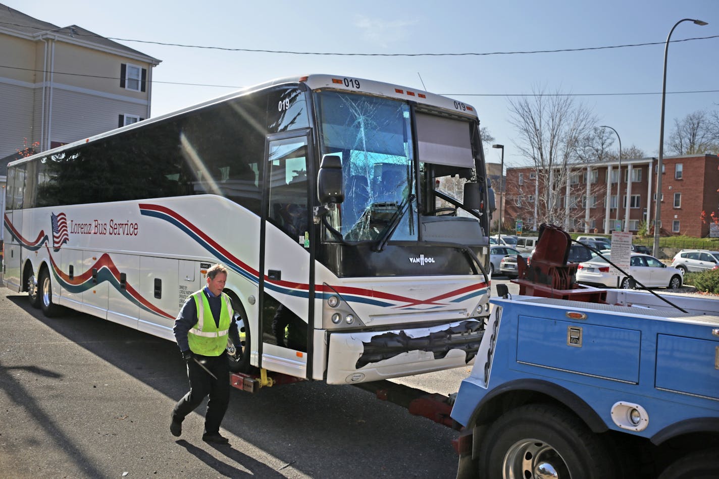 Tom Lynch of Twins Cities Towing and Recovery prepares one of two buses involved in an earlier accident for towing. Two Washington Redskins team buses collided about 8:15 a.m. Sunday morning.