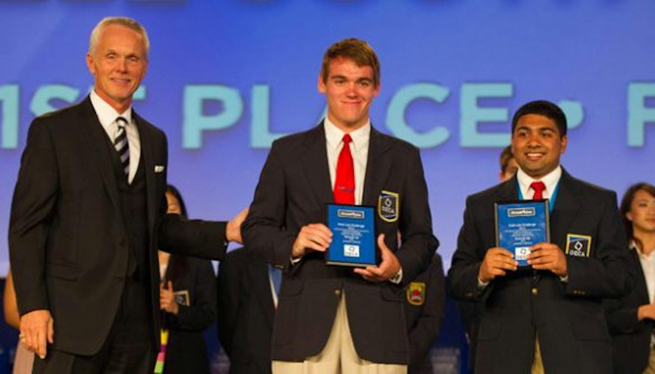 Courtesy of Ann Myers Joel Varghese, right, and Brandon Sell accepted their award at the DECA International Career Development Conference last year in April 2013.
