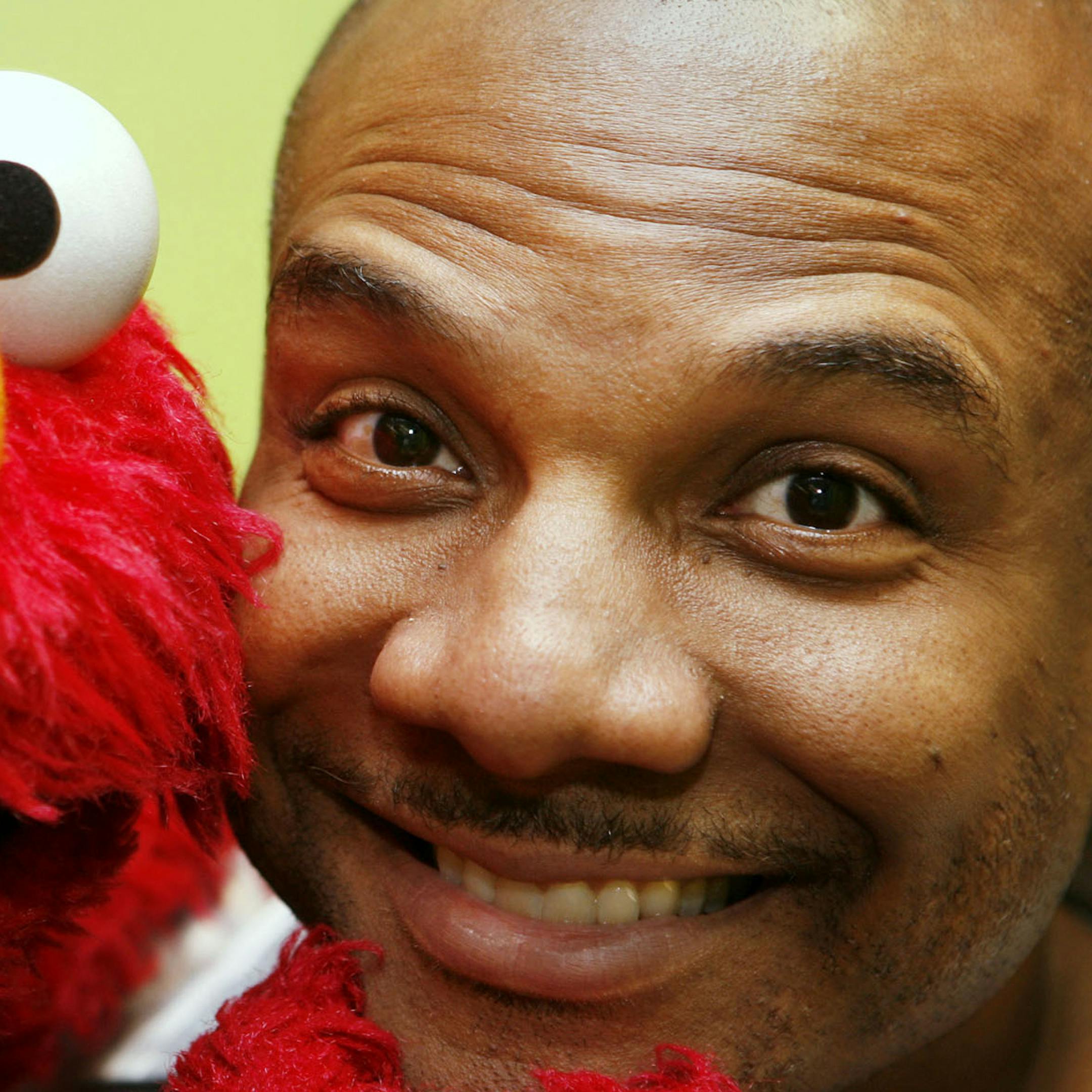 FILE - This Aug 16, 2006 file photo shows Kevin Clash, who was the voice and movements behind Sesame Street's Elmo, posing for a picture with Elmo in New York. Three lawsuits brought by men who said Clash sexually abused them when they were underage were tossed out by a federal judge who said in a decision published Monday, July 1, 2013, that the men waited too long to sue. (AP Photo/Seth Wenig, File)