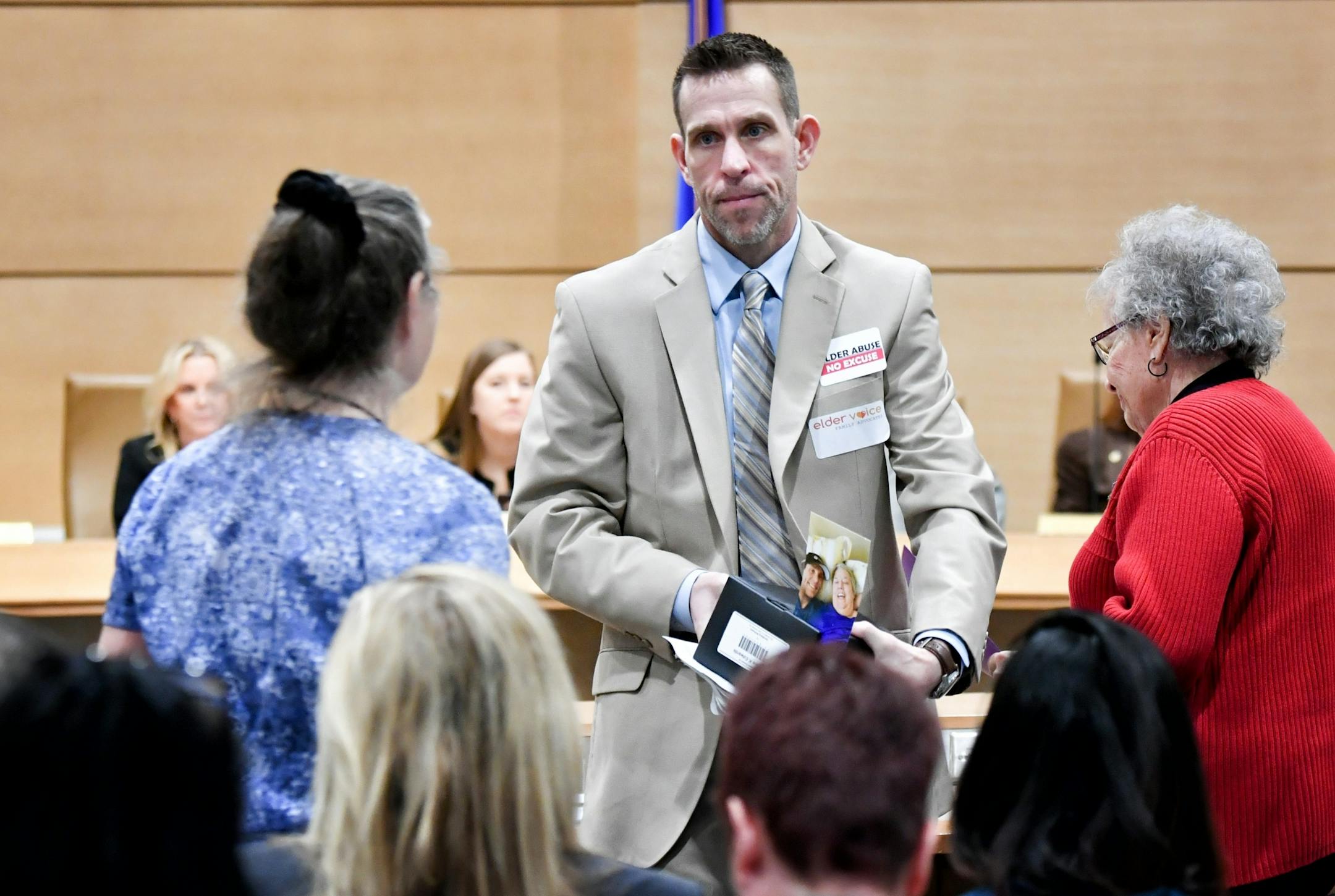 With a box of his dead mother's ashes on the desk in front of him, Kent Edwards described how she was abused by two caregivers at a Lino Lakes assisted-living facility.