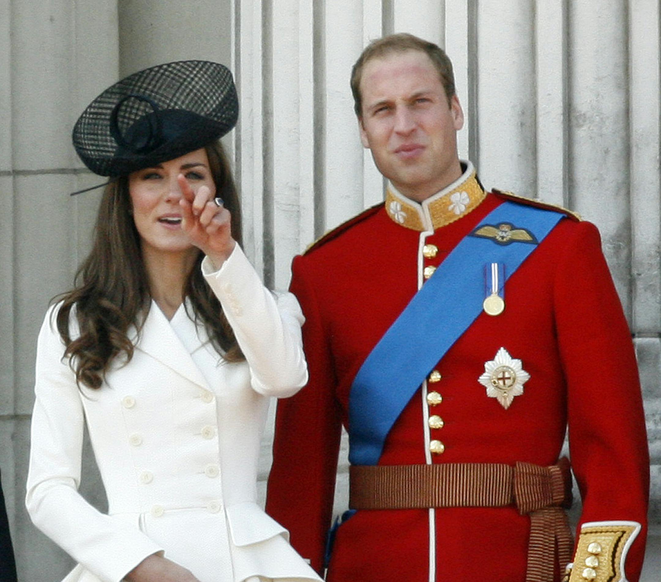 FILE - Britain's Prince William, Duke of Cambridge, right, his wife Catherine, Duchess of Cambridge, react on the balcony of Buckingham Palace after returning from the Trooping the Colour ceremony to mark the Queen's official birthday in London, in this, June 11, 2011 file photo. Among the roughly 5 million visitors expected in New York this holiday season, at least two are certain to get the royal treatment: Britain’s Prince William and his wife, Kate. They’re due to arrive Sunday