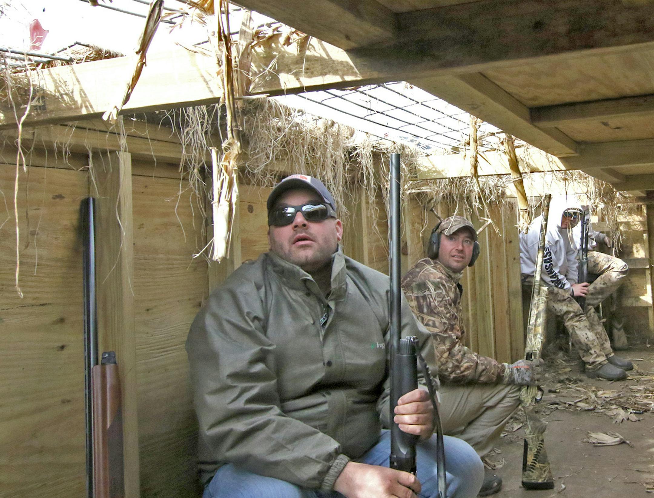 Chris Ward of South St. Paul and Mike Wenzel of Minneapolis hug the wall of an underground waterfowl blind as a line of snow geese approach from the south. The pit near Henry, S.D., was used for six weeks this year to hunt the spring migration of a goose population that has grown too large, damaging habitat for other wildlife in the arctic tundra, where the birds summer.