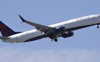 FILE- In this May 24, 2018, file photo a Delta Air Lines passenger jet plane, a Boeing 737-900 model, approaches Logan Airport in Boston. Airlines are