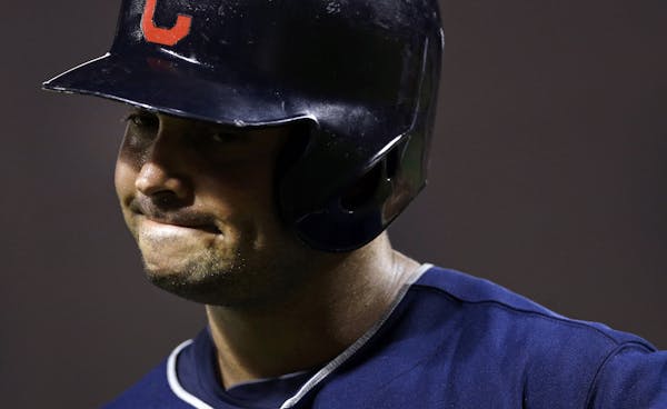 Cleveland Indians' Nick Swisher reacts as he walks off the field after striking out swinging in the eighth inning of a baseball game against the Balti