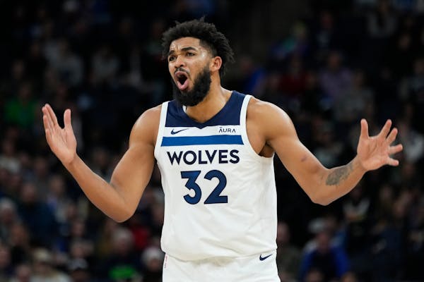 Minnesota Timberwolves center Karl-Anthony Towns (32) looks to a referee during the second half of the team's NBA basketball game against the Utah Jaz