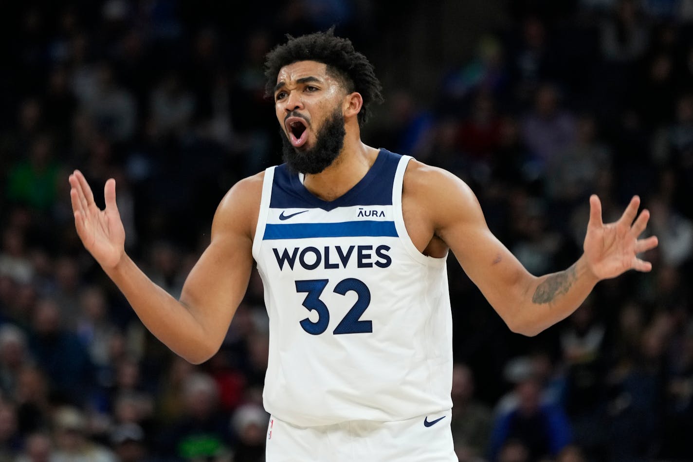 Minnesota Timberwolves center Karl-Anthony Towns (32) looks to a referee during the second half of the team's NBA basketball game against the Utah Jazz, Thursday, Nov. 30, 2023, in Minneapolis. (AP Photo/Abbie Parr)