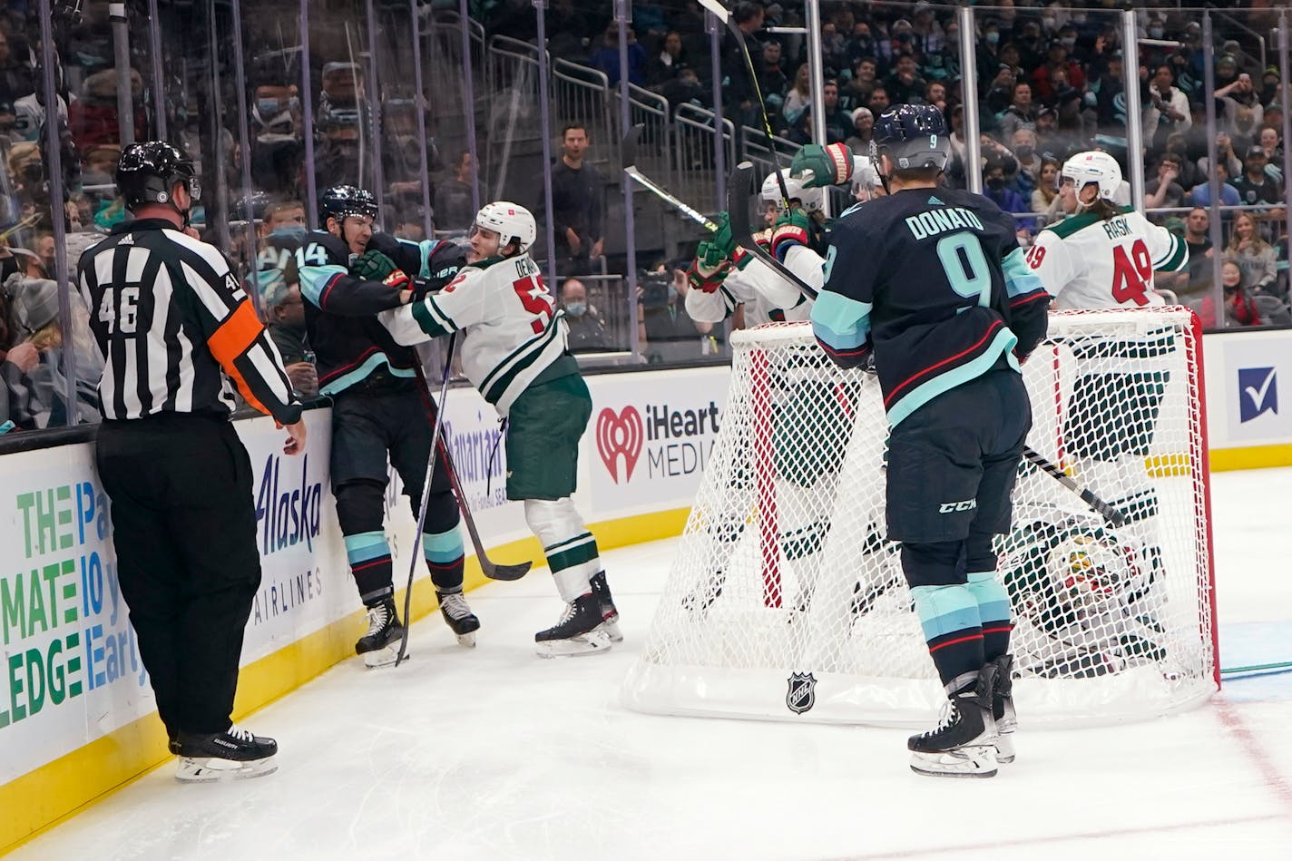 Seattle Kraken right wing Nathan Bastian (14) fights with Minnesota Wild center Connor Dewar (52) during the first period of an NHL hockey game Thursday, Oct. 28, 2021, in Seattle. (AP Photo/Ted S. Warren)