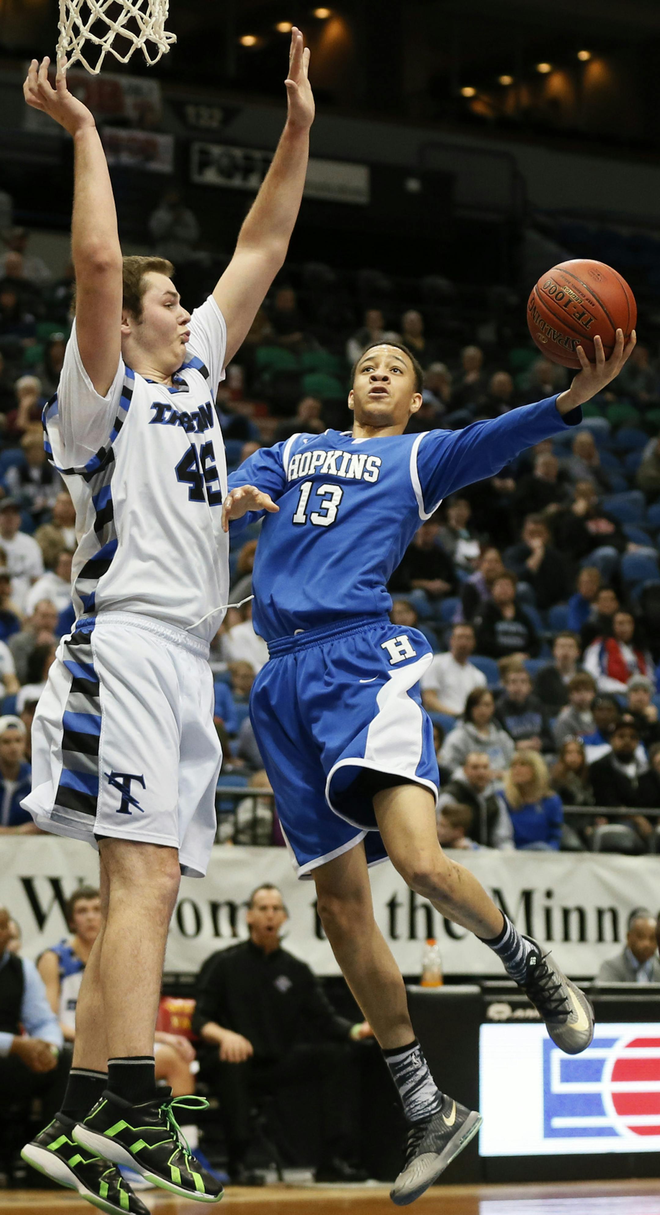 Lanky Hopkins guard Amir Coffey put his wingspan to use against Brody Jackson of Tartan during the Class 4A quarterfinals last season.