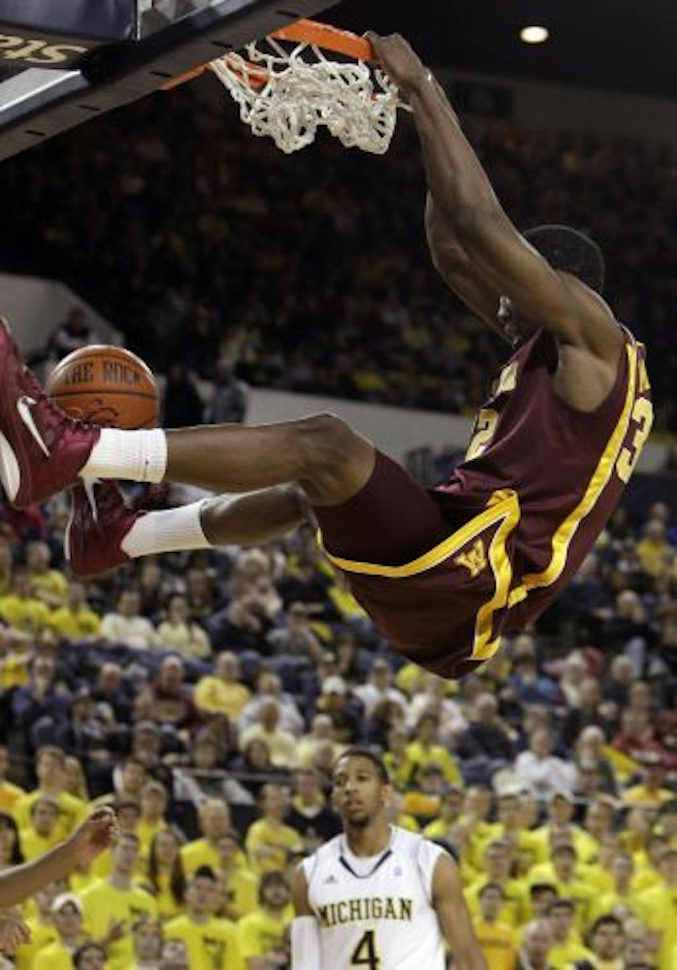 Minnesota forward Trevor Mbakwe (32) dunks during the first half of an NCAA college basketball game against Michigan in Ann Arbor, Mich., Saturday, Jan. 22, 2011.