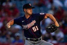 Minnesota Twins starting pitcher Tyler Mahle (51) throws during the first inning of a baseball game against the Los Angeles Angels in Anaheim, Calif.,