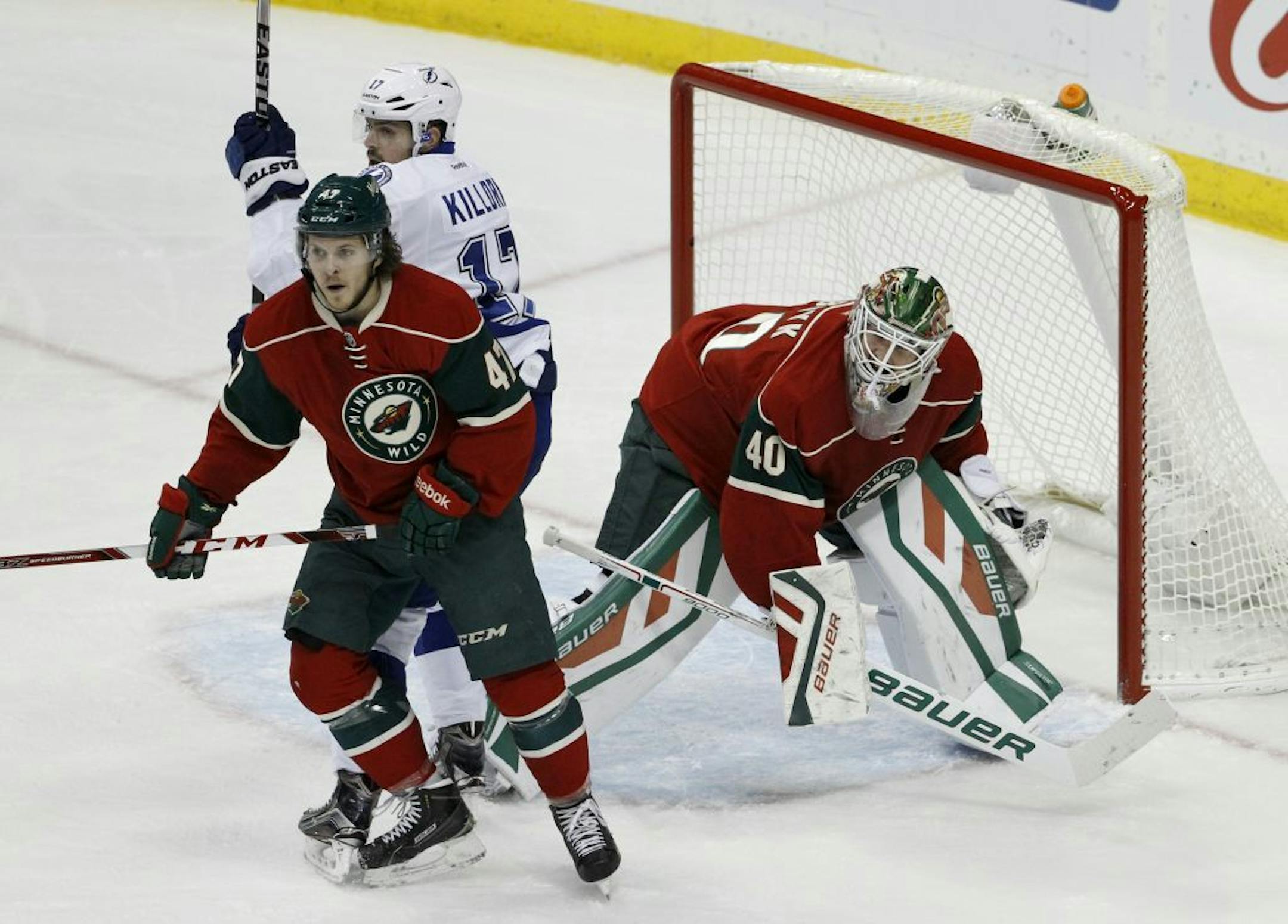 Minnesota Wild center Christoph Bertschy, left