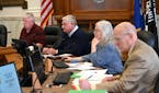 Crow Wing County Commissioners Doug Houge, Steve Barrows and Rosemary Franzen, along with Crow Wing County Attorney Don Ryan, right, listened to speak