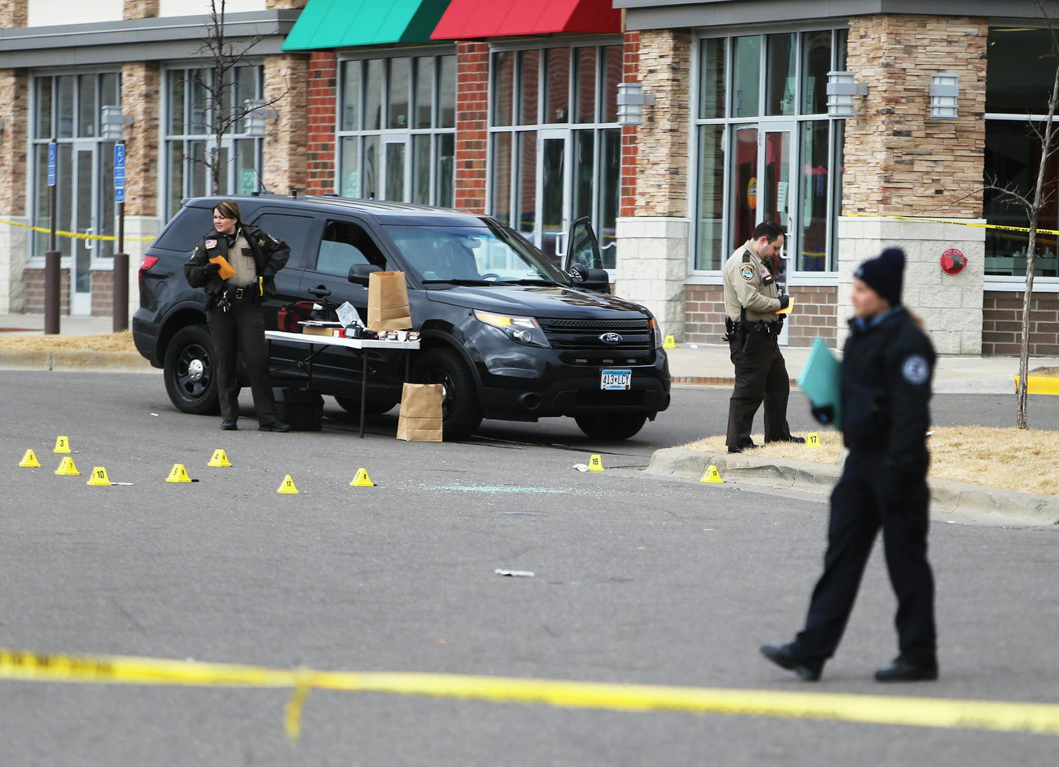 At least two people were hurt when shots were fired outside a Foot Locker at a Brooklyn Center shopping center Saturday morning during a highly anticipated shoe sale. Here, law enforcement officers look over the seen where gun casing littered the parking lot Saturday, March 5, 2016, in Brooklyn Center, MN.](DAVID JOLES/STARTRIBUNE)djoles@startribune.com At least two people were hurt when shots were fired outside a Foot Locker at a Brooklyn Center shopping center Saturday morning during a highly