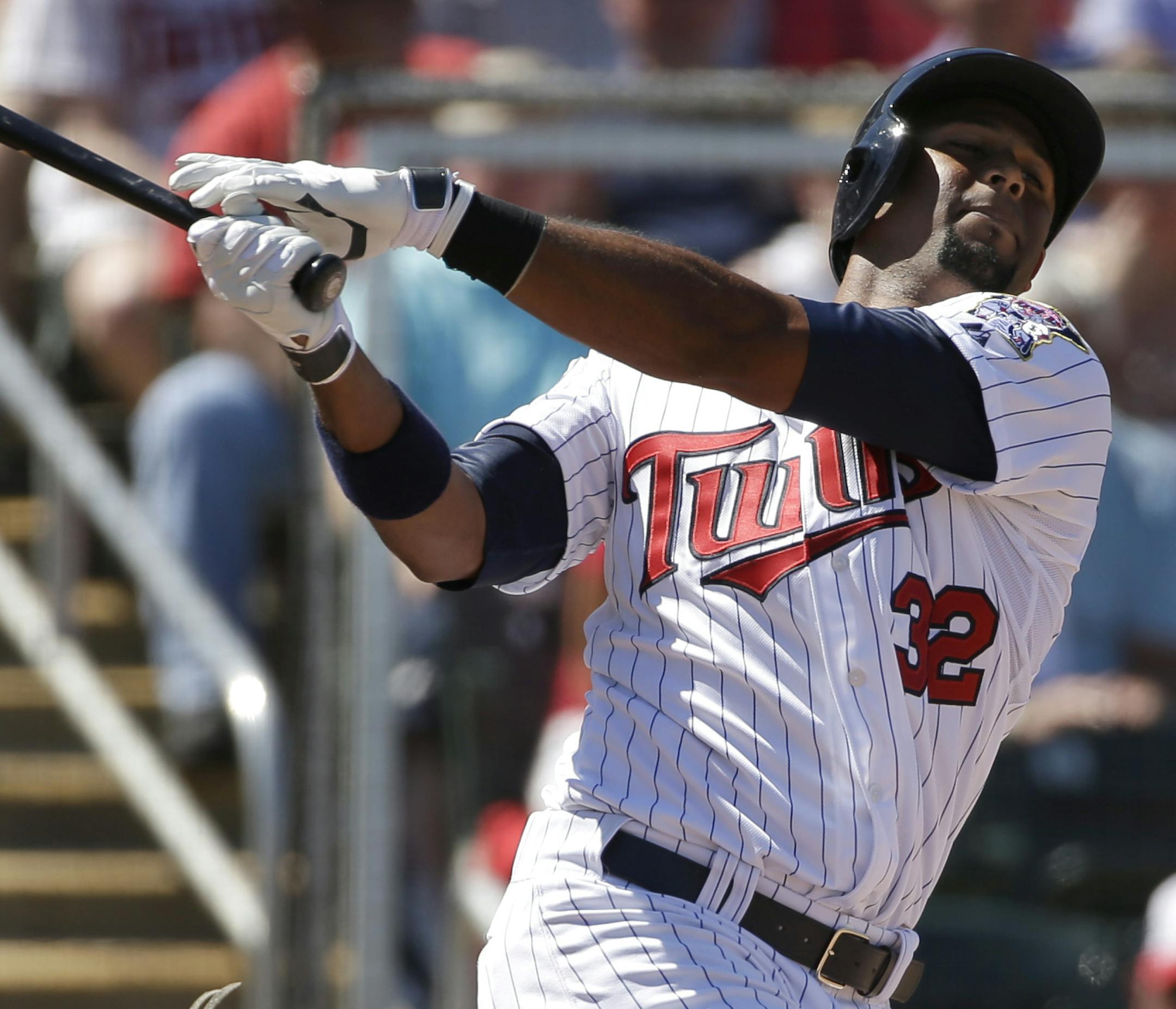 Minnesota Twins' Aaron Hicks follows through on a swing as Boston Red Sox catcher A.J. Pierzynski, left, looks on in the second inning of an exhibition baseball game, Saturday, March 1, 2014, in Fort Myers, Fla. The Twins beat the Red Sox 6-2. (AP Photo/Steven Senne) ORG XMIT: MIN2014033021025246 ORG XMIT: MIN1403302105080196