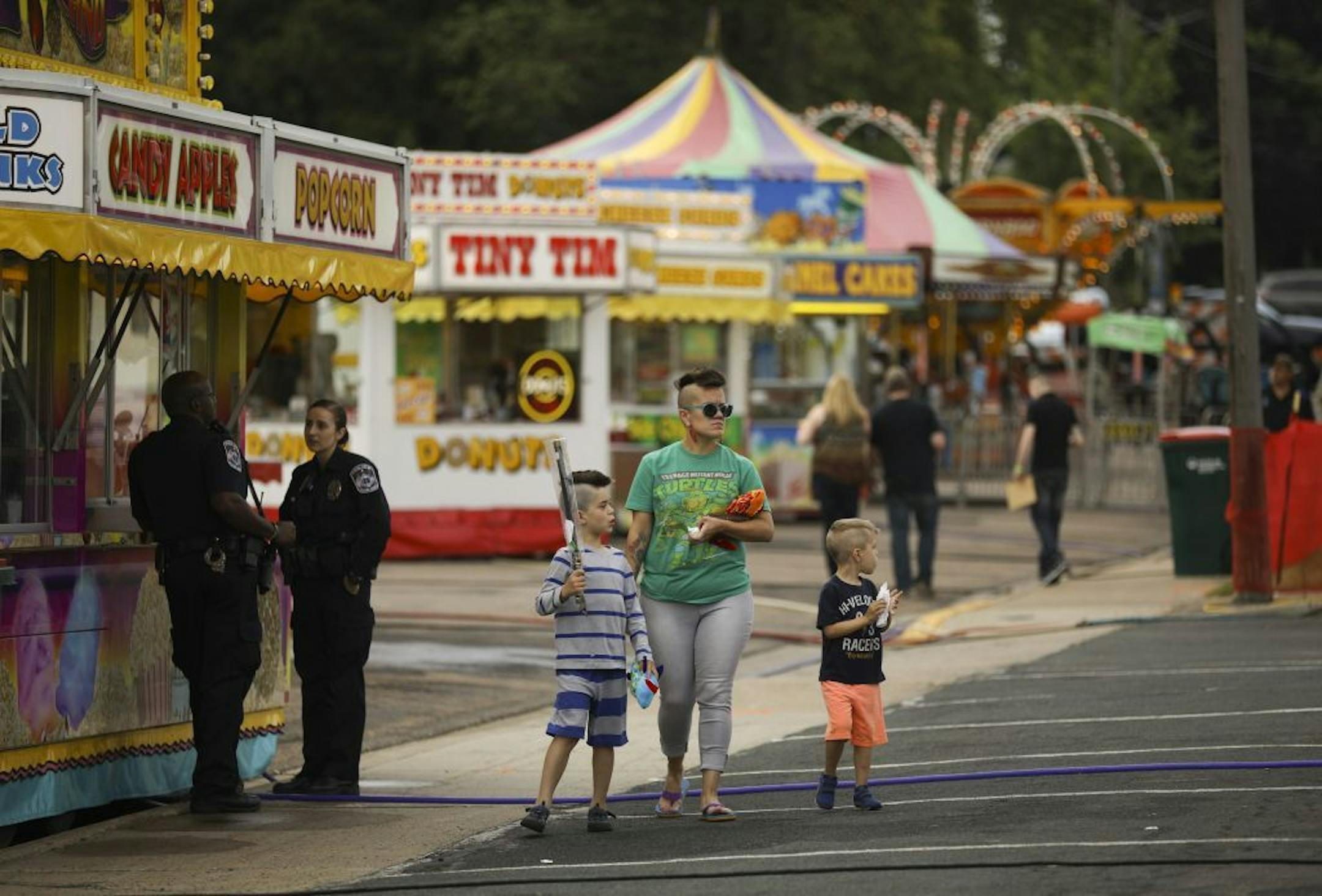 Crystal Vital-Schwartz walked with her boys Xavier, left, and Franklin as they explored at the Columbia Heights Jamboree & Carnival Thursday evening.