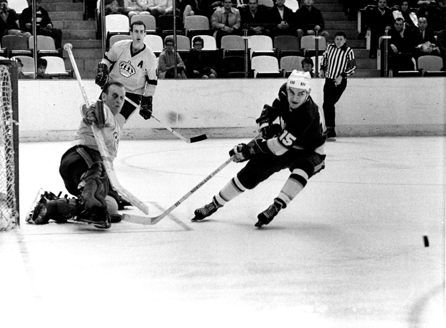 December 13, 1967 North Stars' Andre Boudrias chases the puck after goalie Wayne Rutledge of the Los Angeles Kings stopped his shot in a game at Met Center January 7, 1968 Picture Magazine; Minneapolis Sunday Tribune