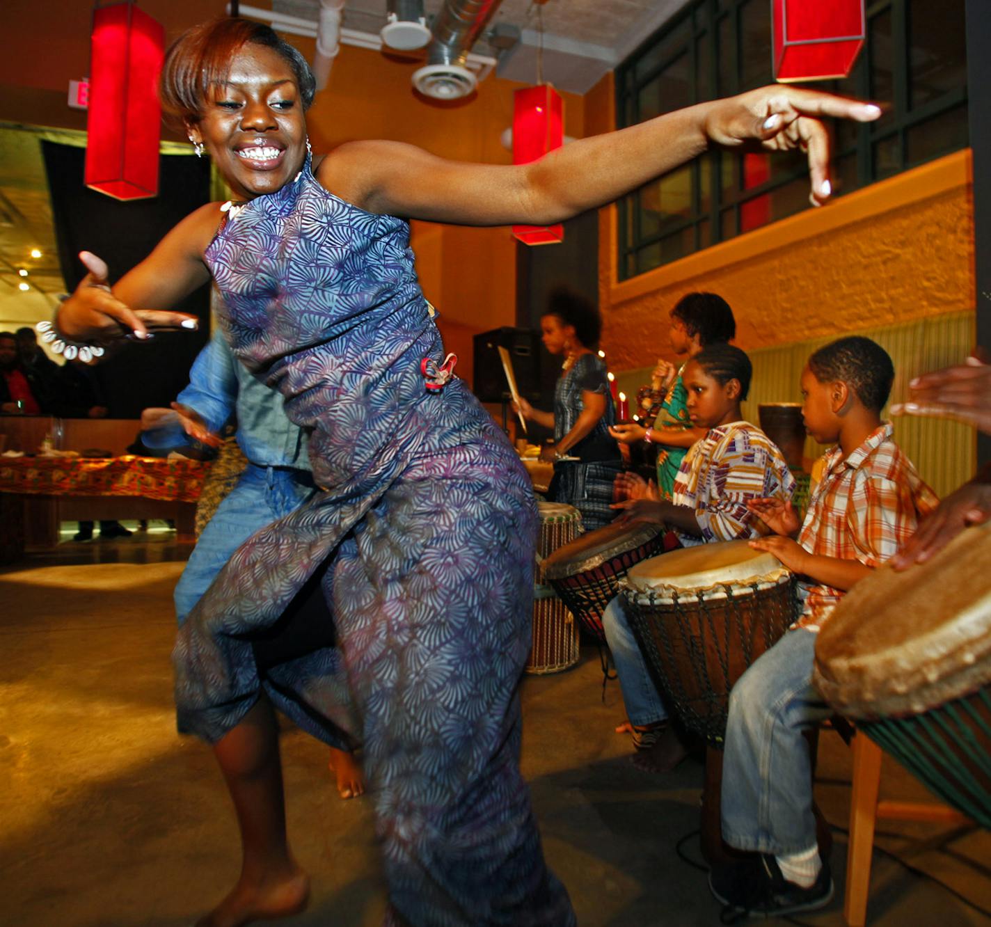 MARLIN LEVISON*mlevison@startribune.com GENERAL INFORMATION : ] Kwanzaa is an African American and Pan-Africa holiday celebrating family, community and culture observed from December 26 through january 1. A local celebration held at the Midtown Global Market on Lake Street in Minneapolis featured dancing, drumming, storytelling, food and games. IN THIS PHOTO: Ashley Akpaka, left a member of the Voice of Culture Druma and Dance team of Minneapolis danced a traditional African dance.