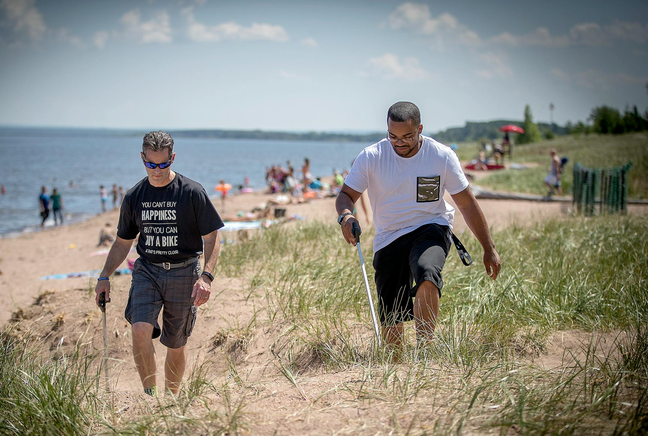 Duluth Judge Shaun Floerke, left, and defendant Emil Green cleaned Park Point beach with other DWI defendants before having a picnic, Friday, July 28, 2017 in Duluth, MN.
