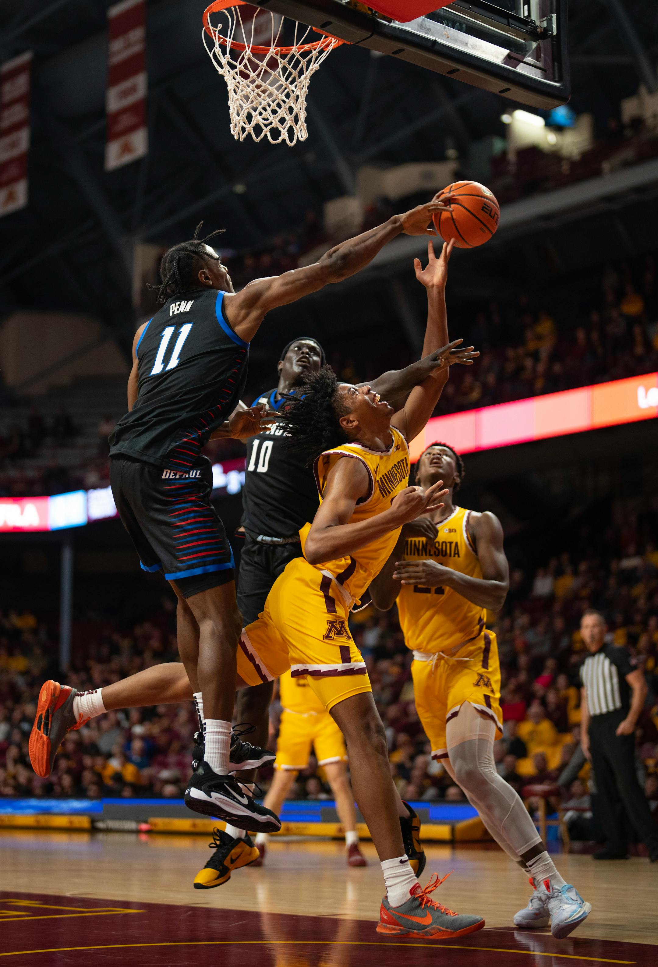 DePaul Blue Demons forward Eral Penn (11) blocked a shot by Minnesota Gophers forward Jaden Henley (24) in the first half.